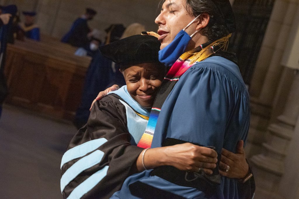 senior associate dean hugging graduate