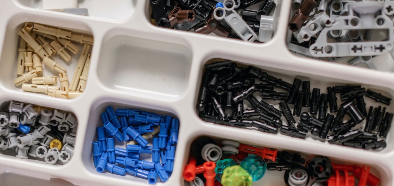 Miscellaneous Lego pieces in a bin with compartments