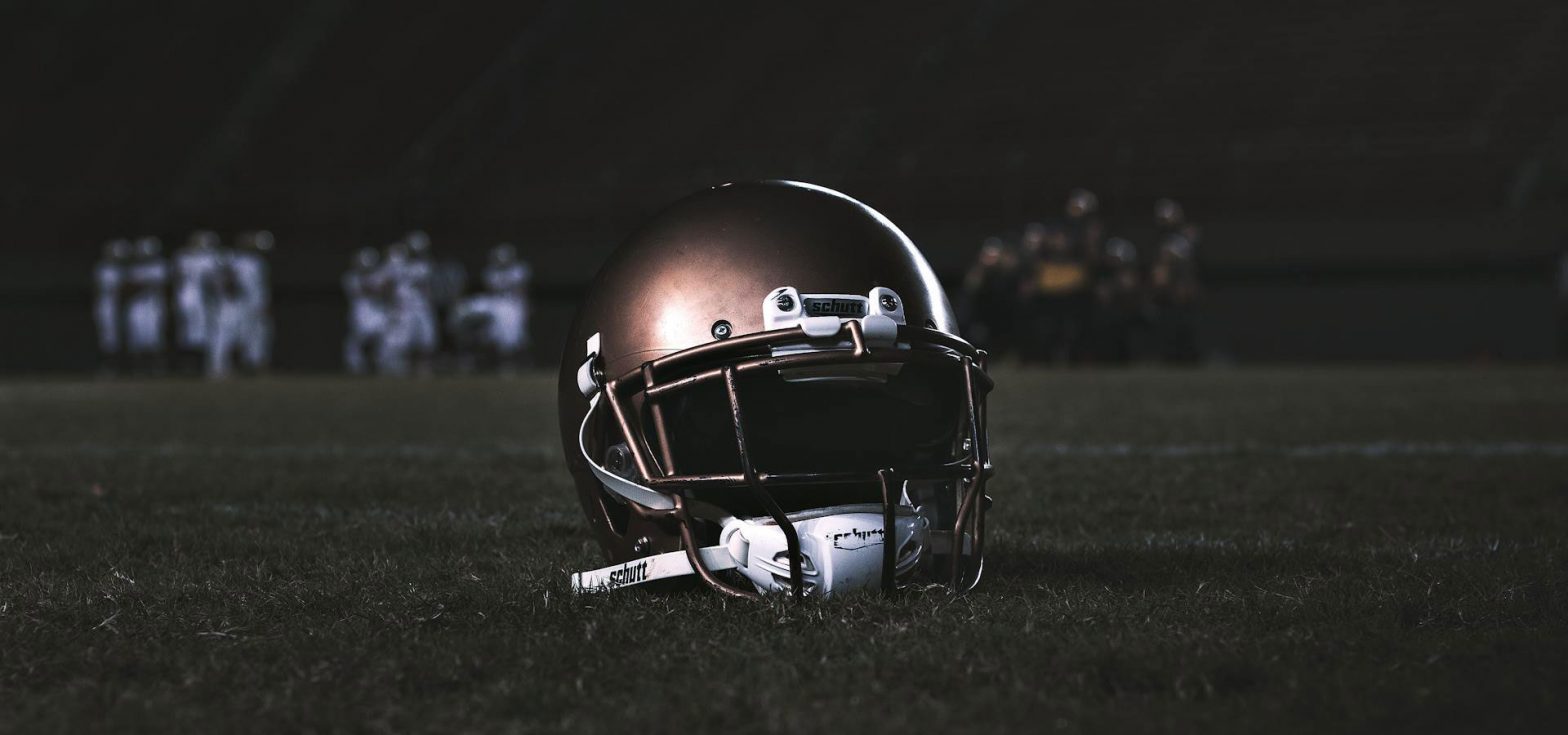 Football helmet sitting on a field