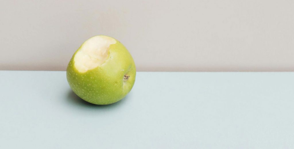 An apple with a bite taken out of it