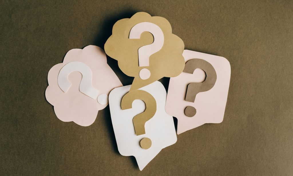 Five cutouts of question marks